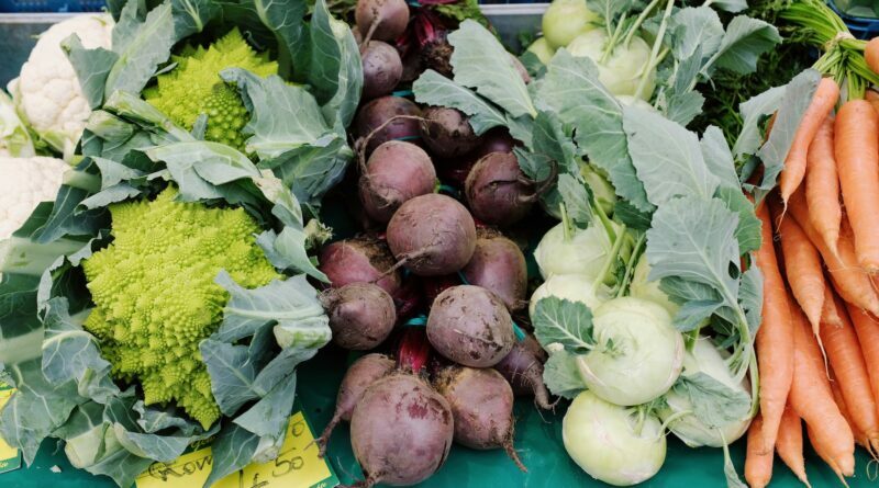 assorted fresh ripe vegetables in market stall