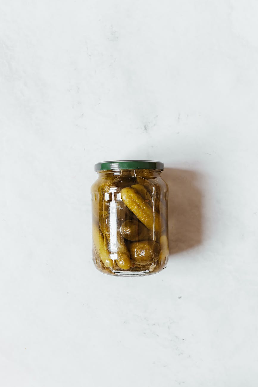 clear glass jar with cucumbers